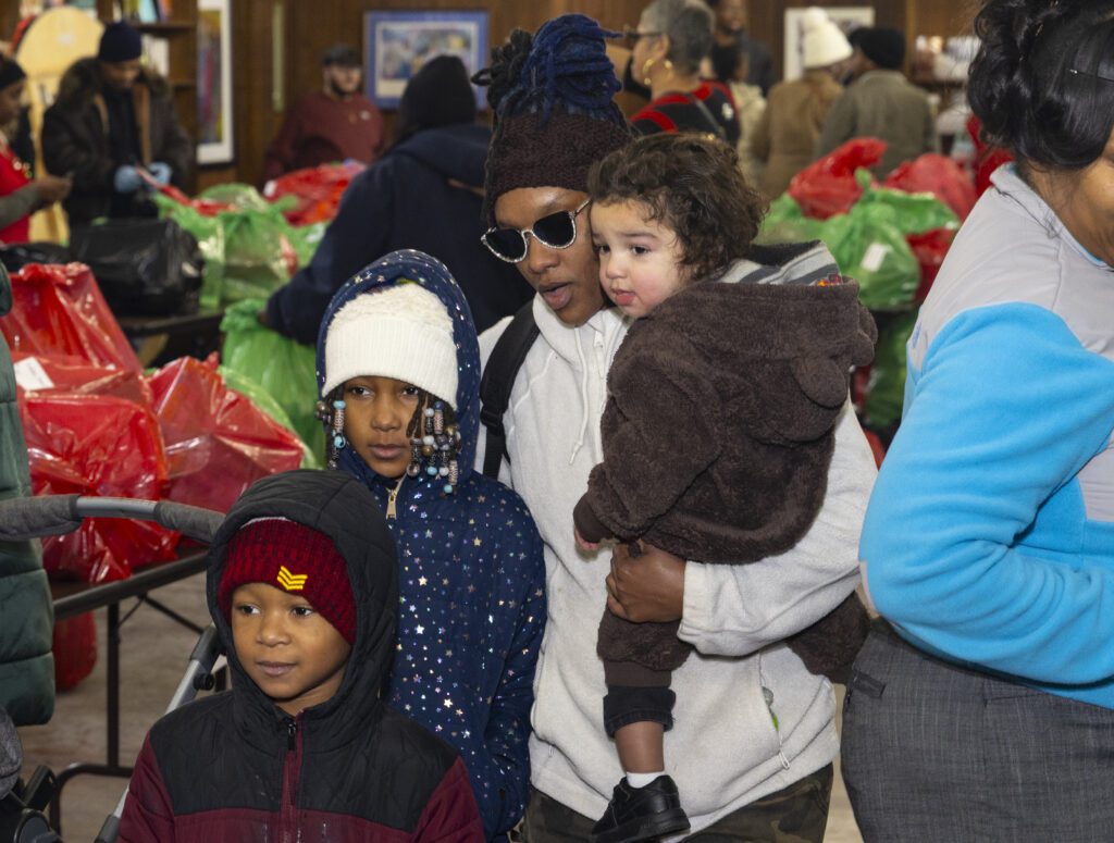 A family at the Make Christmas Very Merry gift pickup
