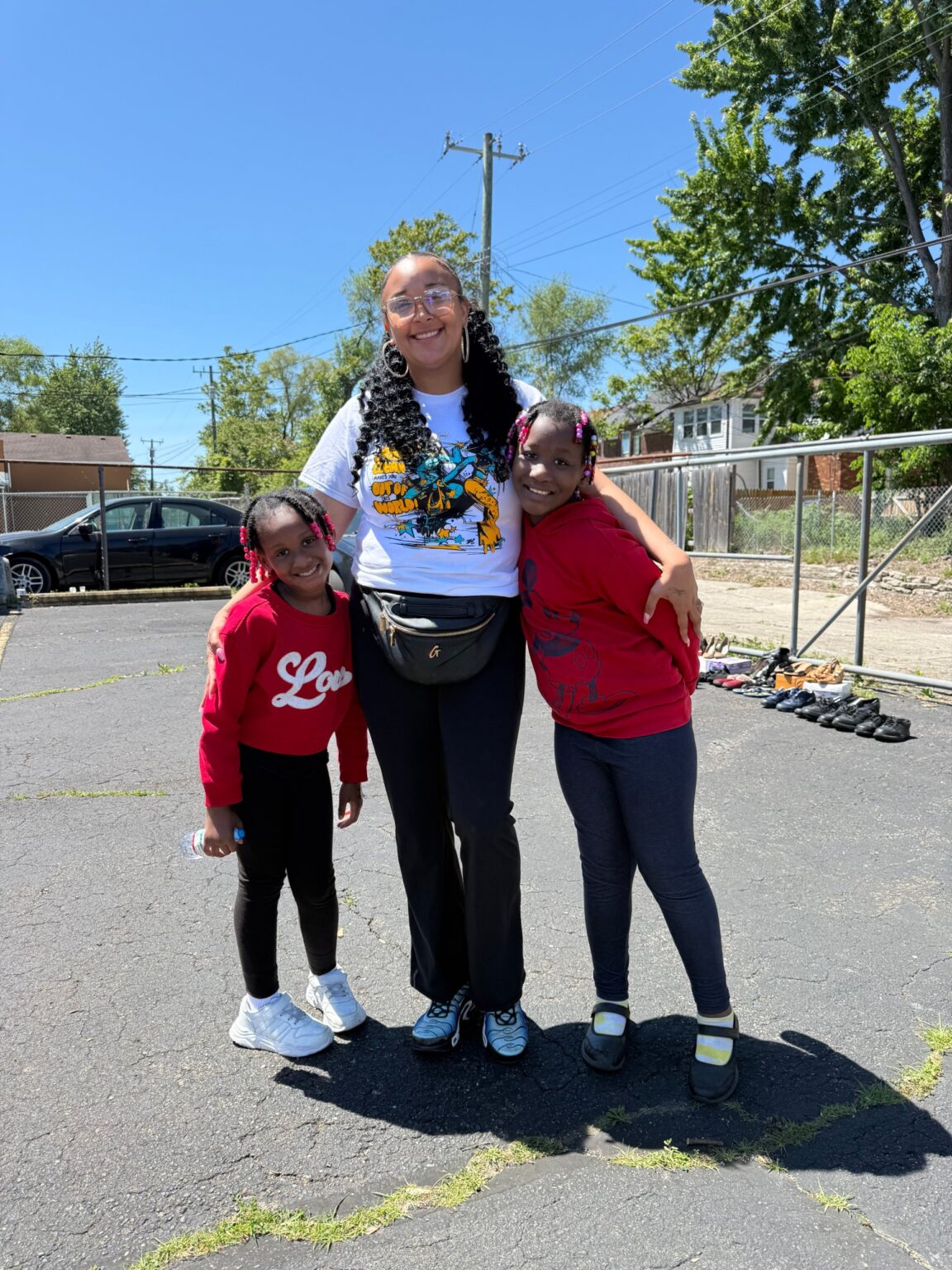 A DABO Detroit staff member with two young girls
